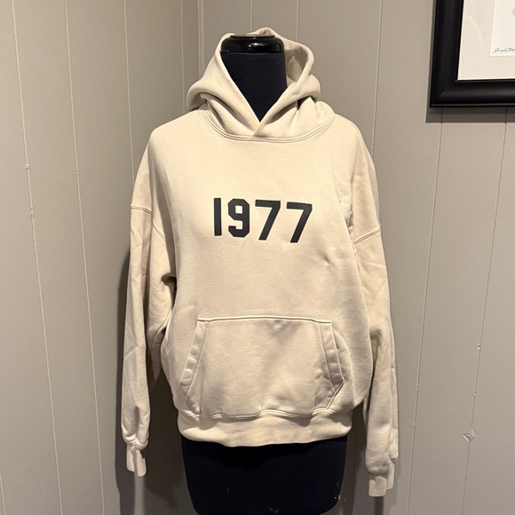 Essentials Women’s 10 Beige Hoodie with Black '1977' Design - Picture 1 of 9